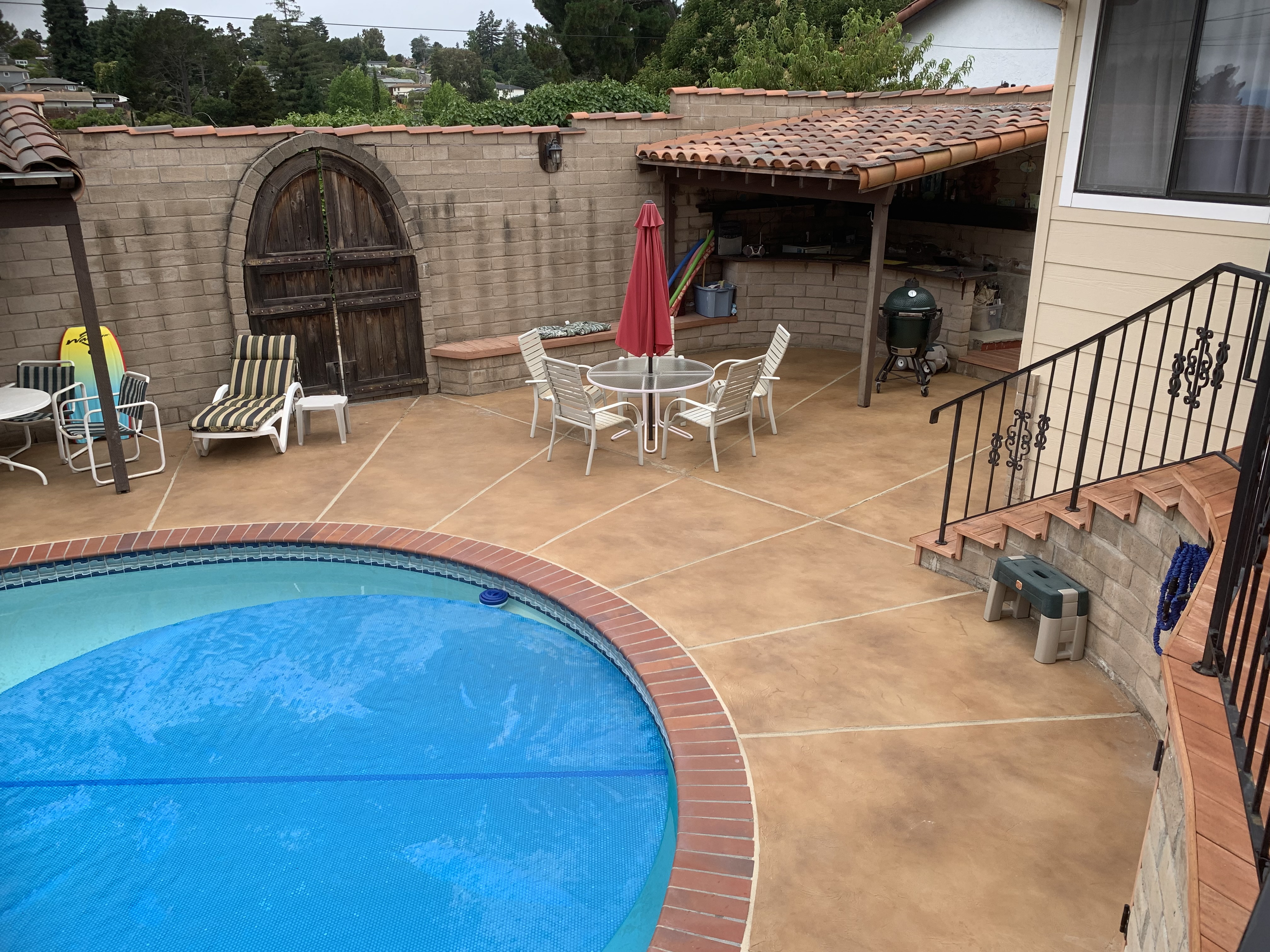 A Serene Pool Surrounded By A Patio Featuring Stylish Outdoor